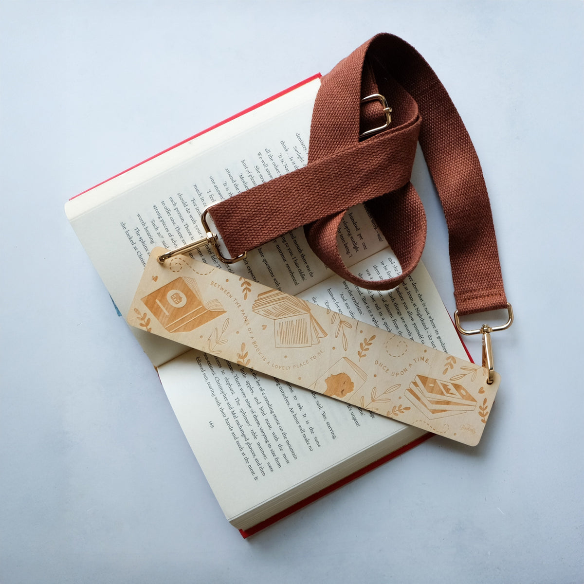 Flat lay photo of the Bookishly Bookmark Purse on a grey background.