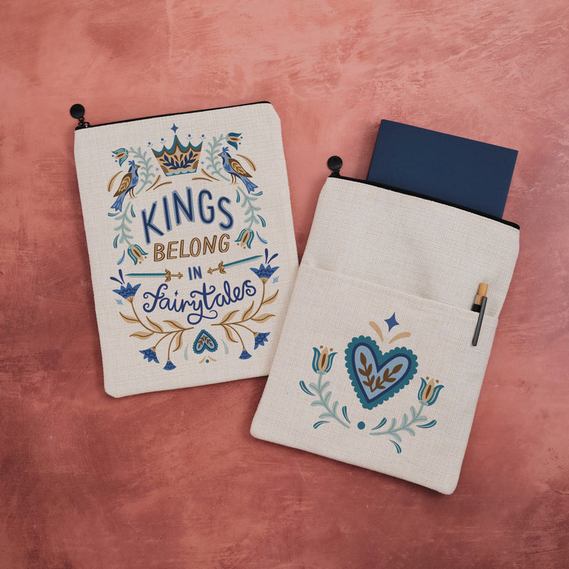 Linen-look book sleeve with Nordic folk art design reading Kings Belong in Fairytales
