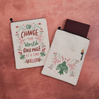 Linen-effect book sleeve with Scandinavian folk art quote Change the World One Page at a Time