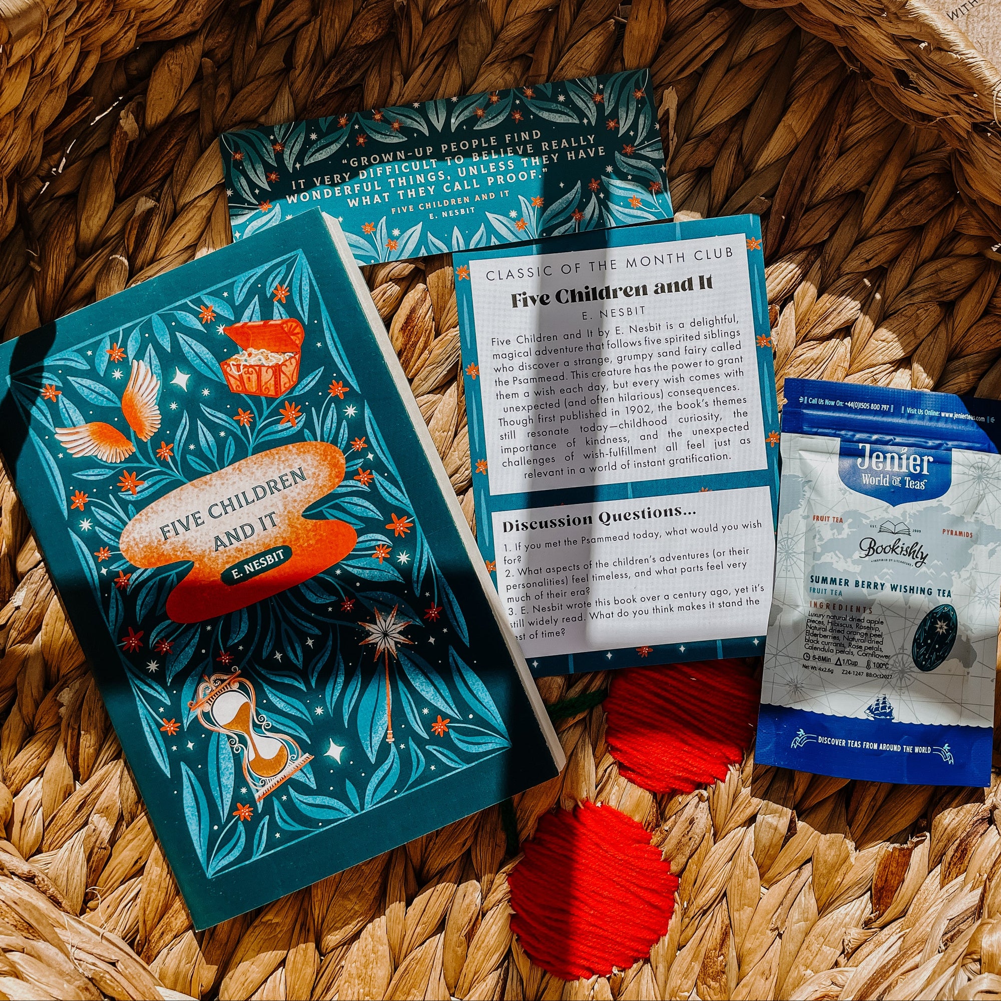 Books and a tea bag on a woven basket with a patterned background