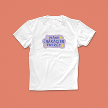 Main Character Energy T-shirt with purple and yellow hand-drawn text and sparkles, perfect for book lovers with big story vibes