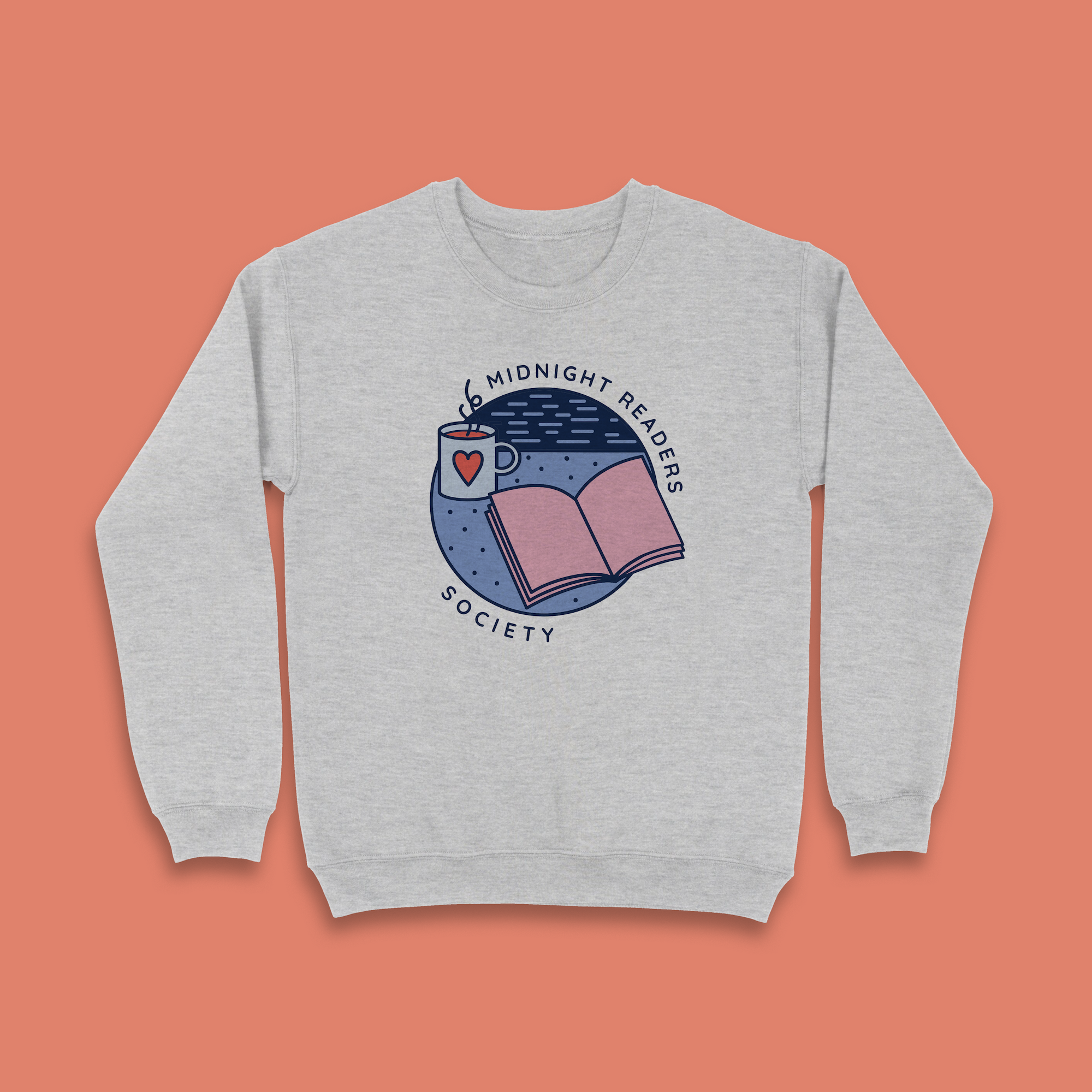 Grey sweatshirt with “Midnight Readers Society” design featuring an open book, mug with heart, and night sky illustration.