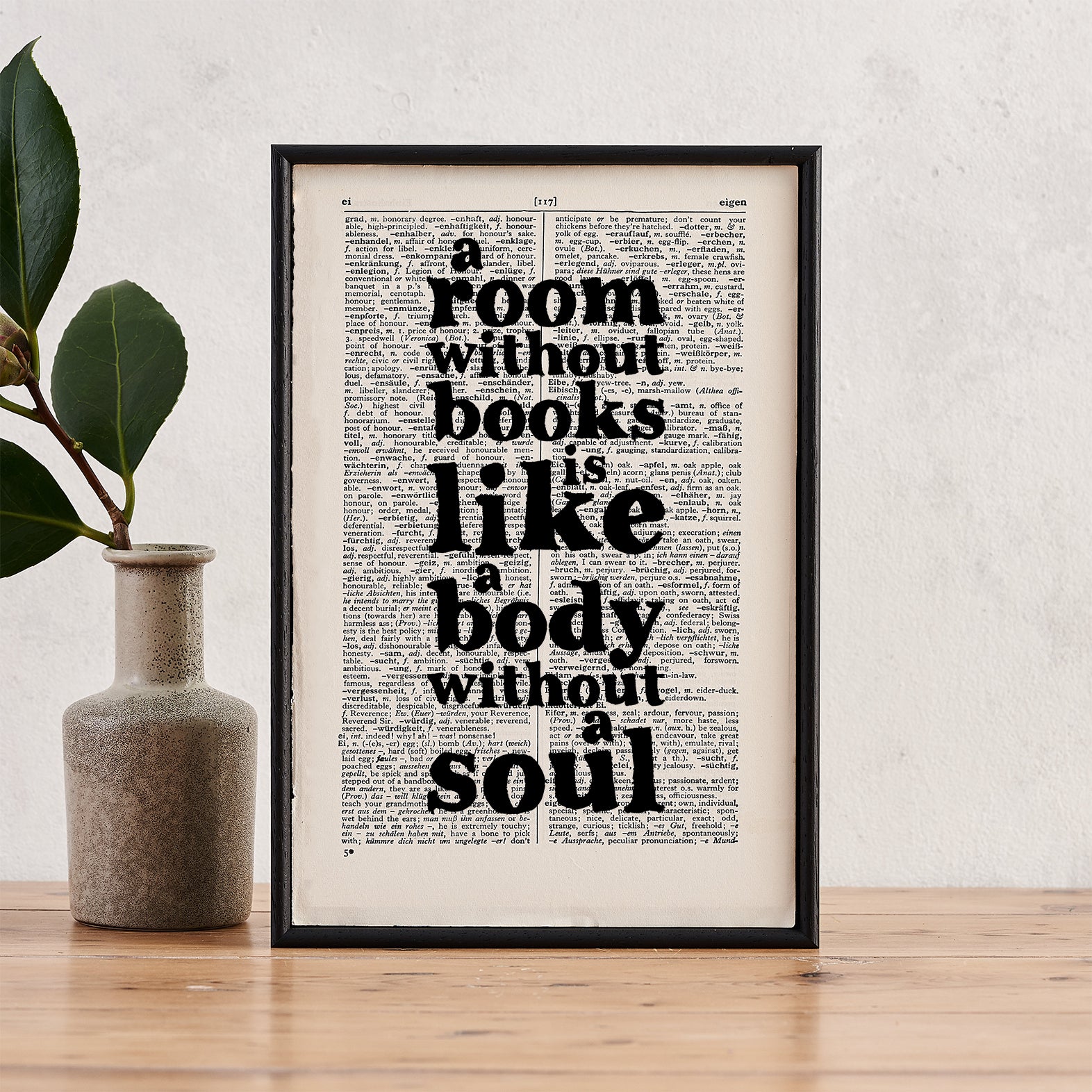Framed vintage-style print with the quote “A room without books is like a body without a soul” printed on a dictionary page