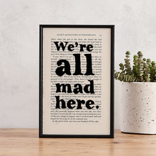 Framed book page print with the quote “We’re all mad here” from Alice’s Adventures in Wonderland.