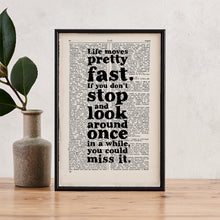 Framed quote print featuring the Ferris Bueller quote “Life moves pretty fast” on a vintage dictionary page