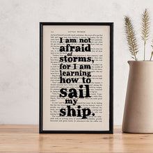 Framed quote print featuring “I am not afraid of storms” from Little Women on a book page
