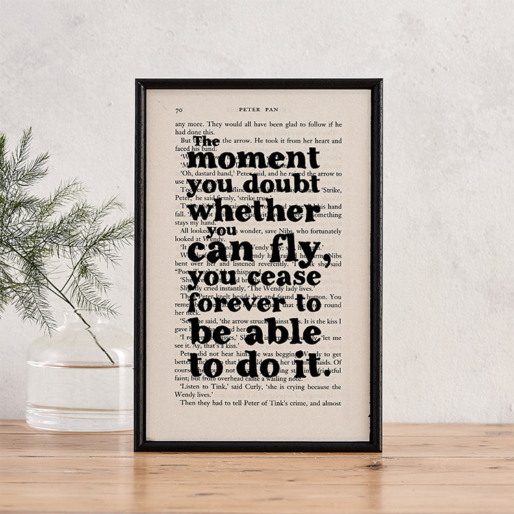 Framed book page print with the quote “The moment you doubt whether you can fly, you cease forever to be able to do it” from Peter Pan.