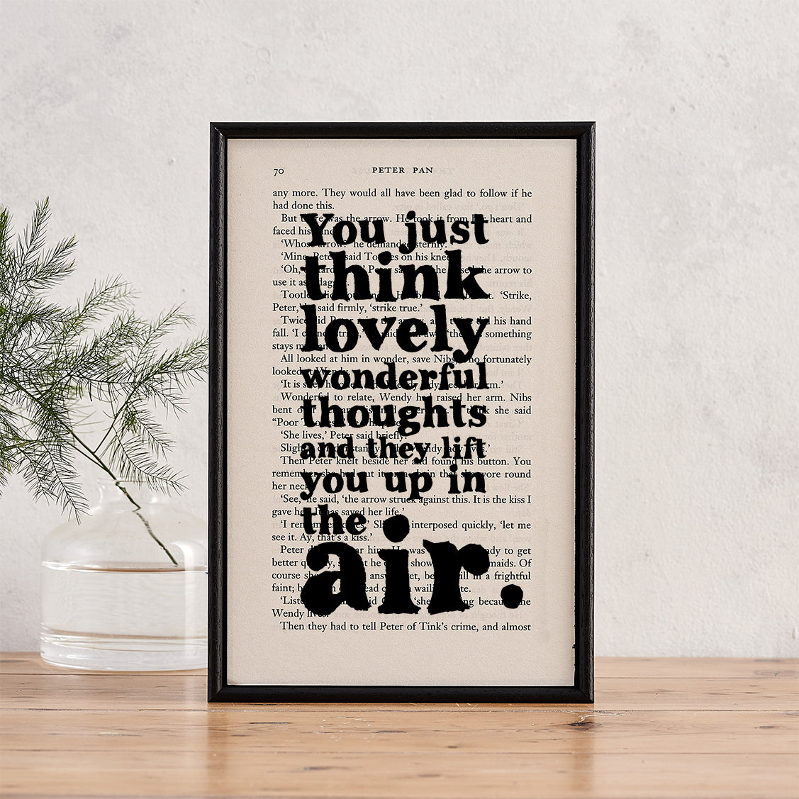 Framed book page print featuring the quote “You just think lovely wonderful thoughts and they lift you up in the air” from Peter Pan.