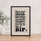 Framed book page print featuring the quote “You just think lovely wonderful thoughts and they lift you up in the air” from Peter Pan.