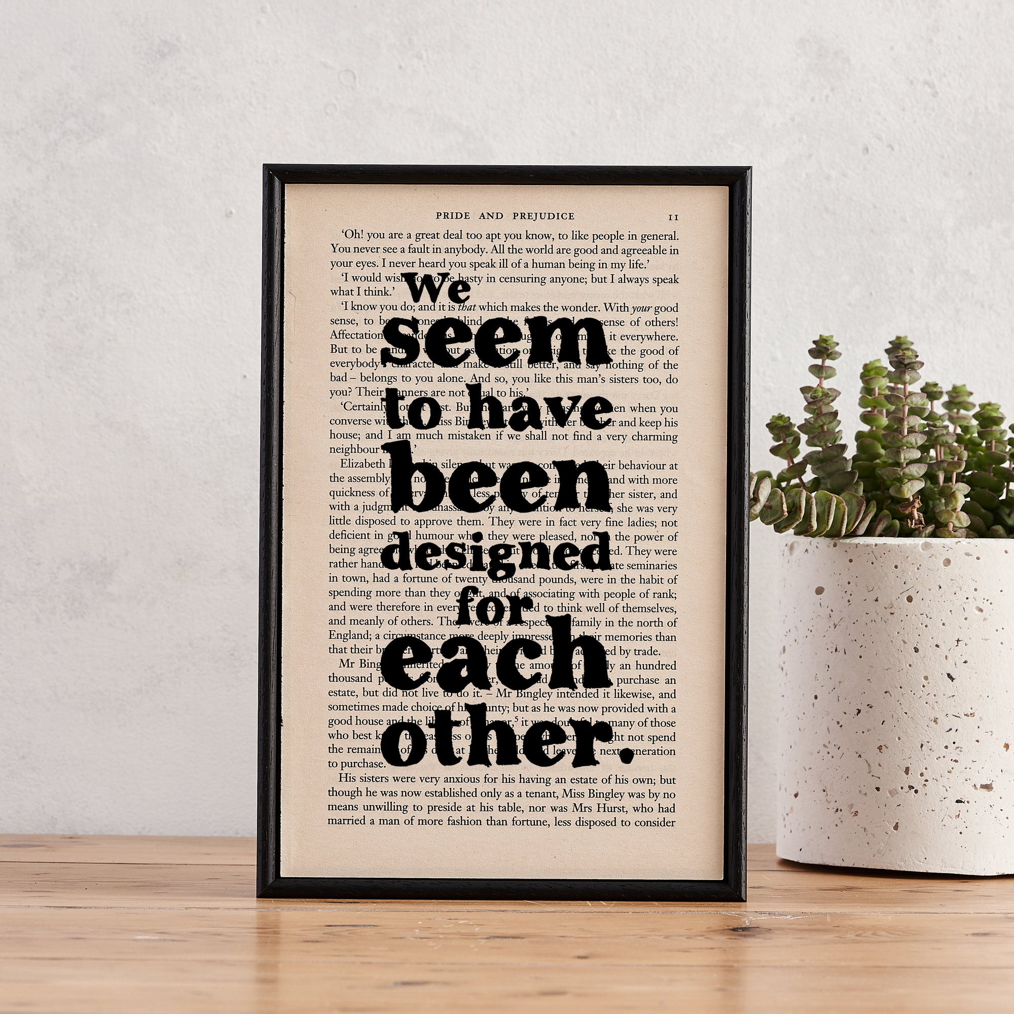 Framed book page print featuring the quote “We seem to have been designed for each other” from Pride and Prejudice.

