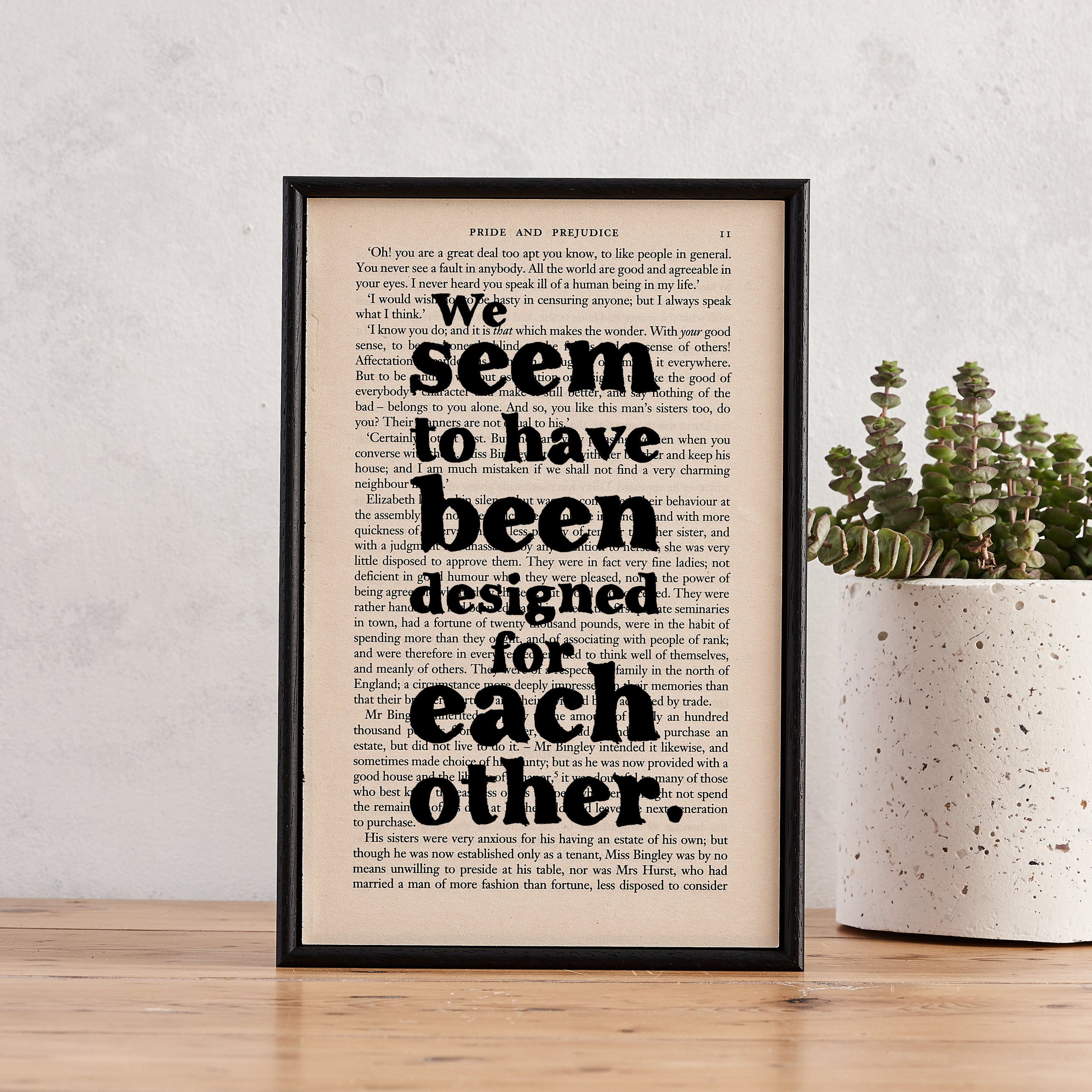 Framed book page print featuring the quote “We seem to have been designed for each other” from Pride and Prejudice.

