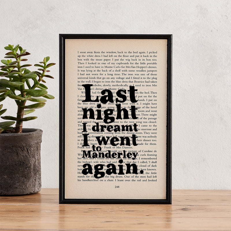 Framed book page art featuring the quote: “Last night I dreamt I went to Manderley again” from Rebecca by Daphne du Maurier.