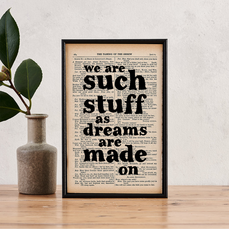 Framed book page print with the quote “We are such stuff as dreams are made on” printed in black text onto a page from The Complete Works of William Shakespeare.