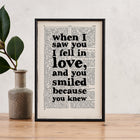 Framed book page print featuring the quote “When I saw you I fell in love, and you smiled because you knew” printed in bold black type on a vintage-style book page.